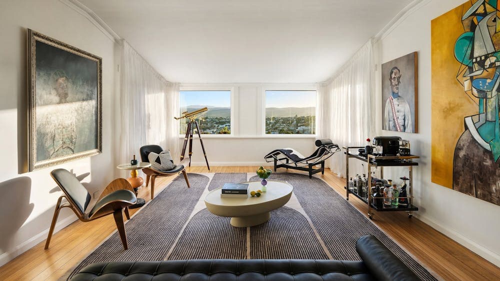 An art deco inspired living area with windows looking out over Launceston, Tasmania.
