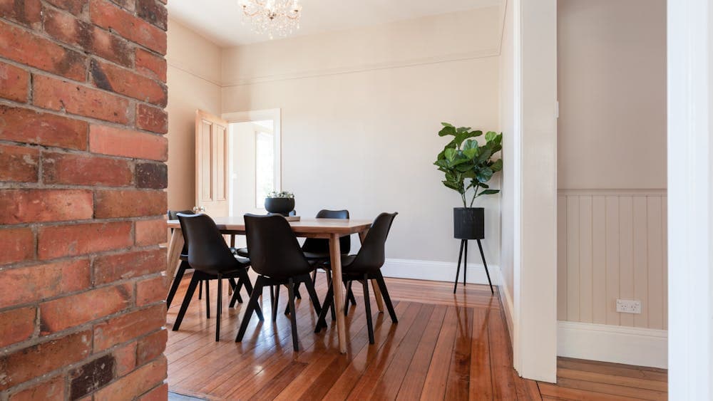 Dining area with heritage brick feature at Gorgeous on Galvin holiday home