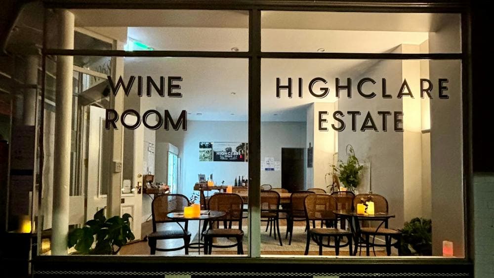 External view of Highclare Wine Room , art deco style window signage and view into seating beyond