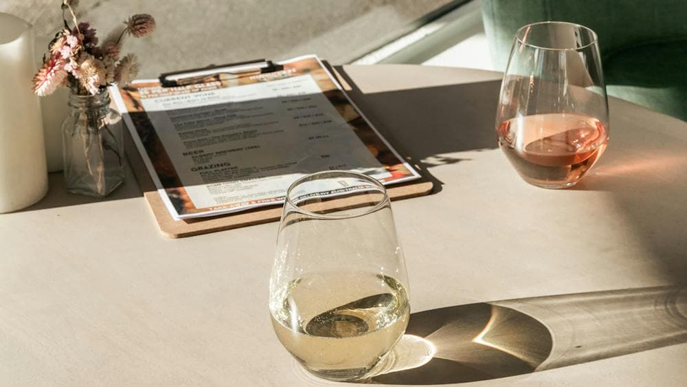 glasses of white and rose wine in the sunshine wine tasting tamar valley