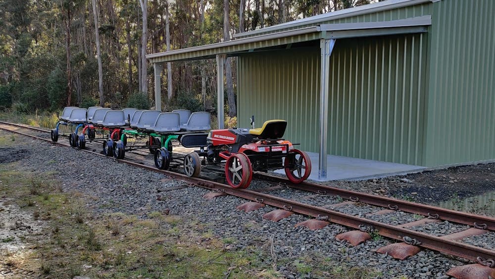 Railbugs  and escort vehicle by the railbug shed.