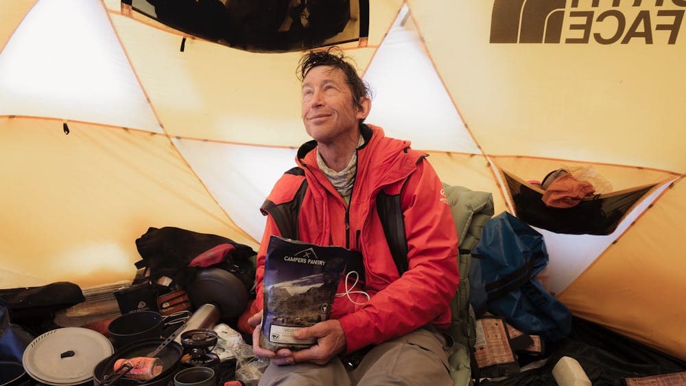 Tim Macartney-Snape enjoying a Campers Pantry meal in the mountains on location wth The North Face