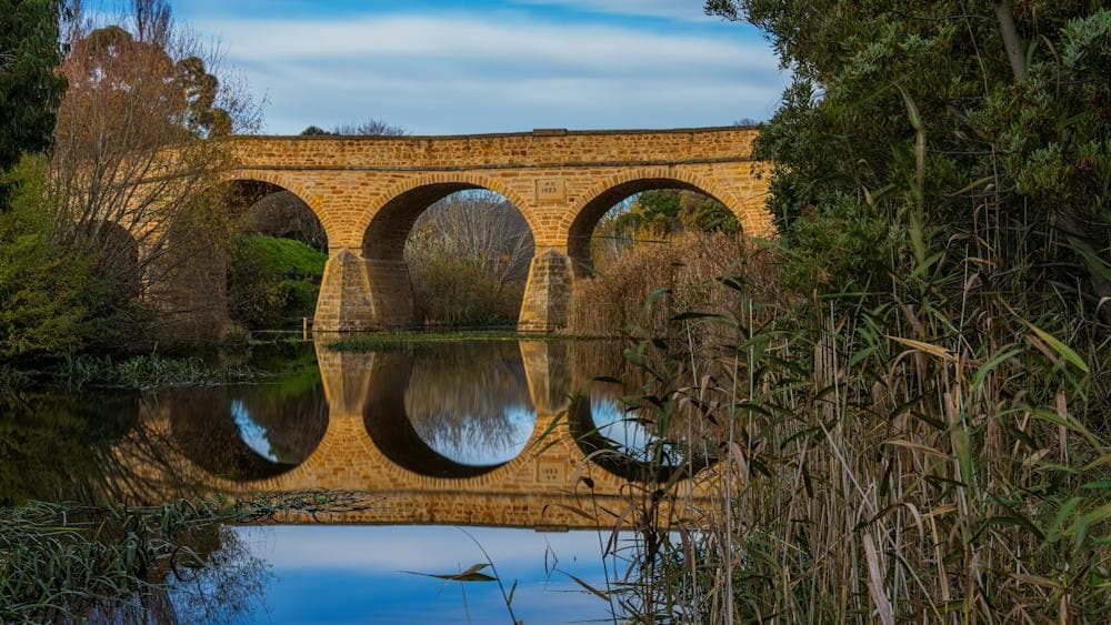 Tasmania's Historical Richmond Bridge reflecting in the Coal River.
