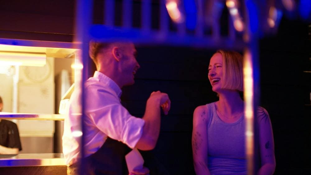 Staff member sharing a laugh with a guest at Mudbar Restaurant in Launceston