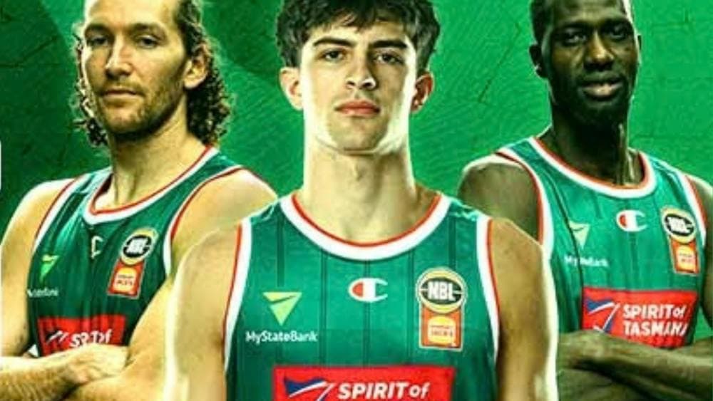 NBL players standing with arms crossed in Jack Jumpers uniform